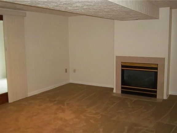 Lower level family room with gas fireplace exiting to the Florida room.