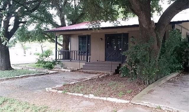 Quaint rustic home located on corner lot with ample shade tr