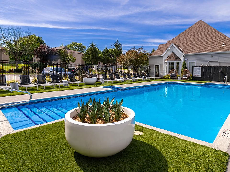 Relax and unwind at our serene poolside area, featuring comfortable lounge chairs, lush greenery, and a tranquil atmosphere perfect for a refreshing swim or sunbathing.
