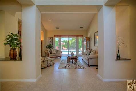Foyer looking into Living Room.  Neutral upgraded tile flooring extends throughout main living areas, with carpeting in the bedrooms.