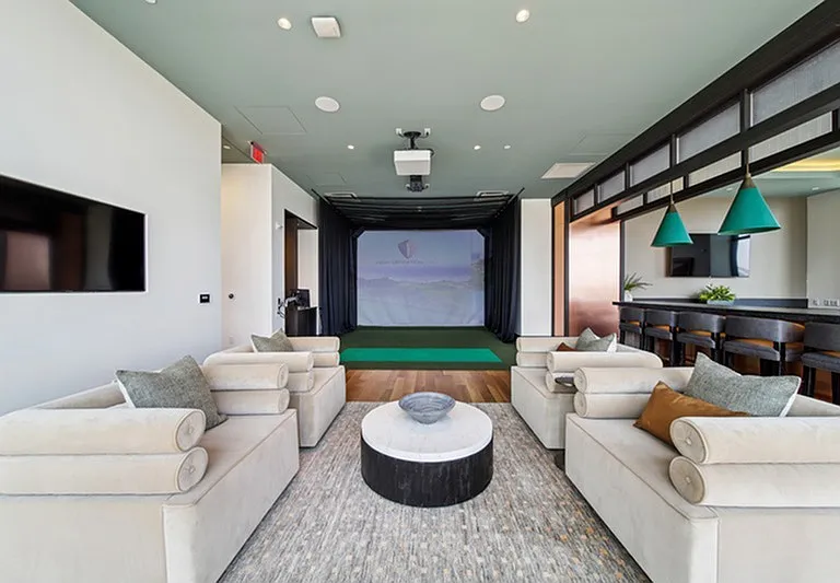 Swing into the virtual fairway _ a stylish golf simulator lounge where precision meets play in a luxe setting.