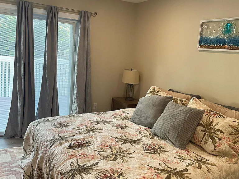 Master with king bed with sliding glass doors to deck.