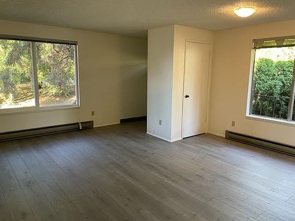Luxury vinyl tile wood floors and large windows highlight the living room and dining area. There is new paint,new floors and new carpets throughout.