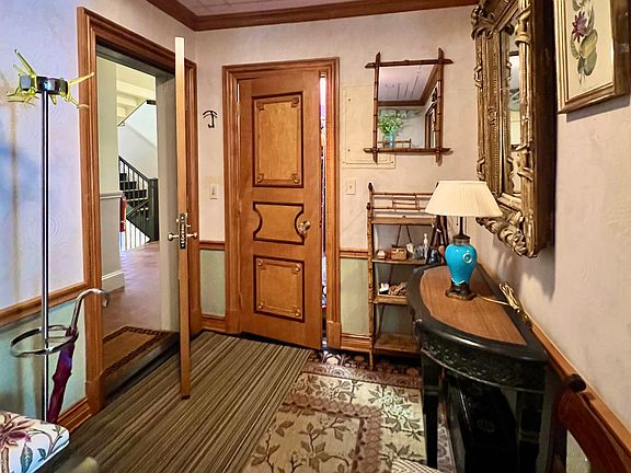 Coat rack and ample closet with lighting and shelves