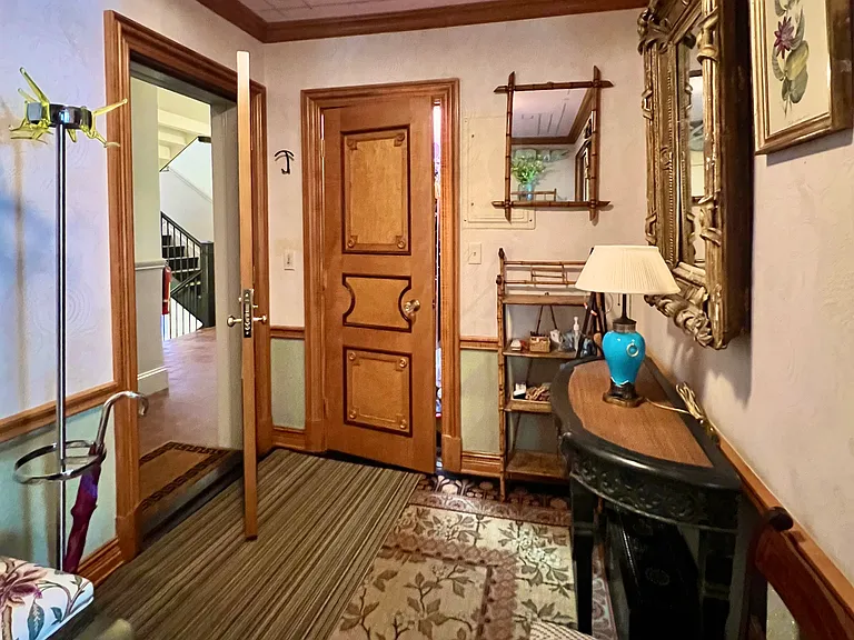 Coat rack and ample closet with lighting and shelves