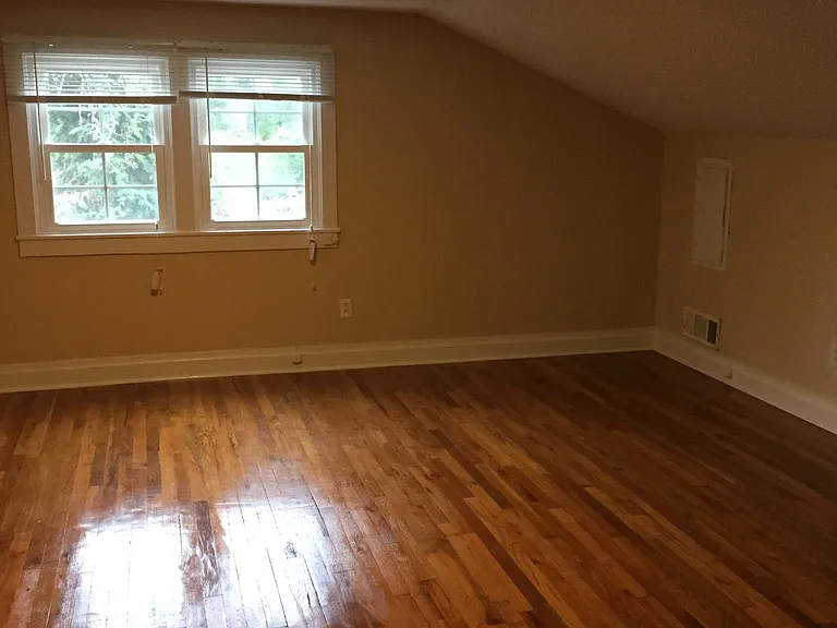 bedroom electric panel on wall right of window and electric outlet