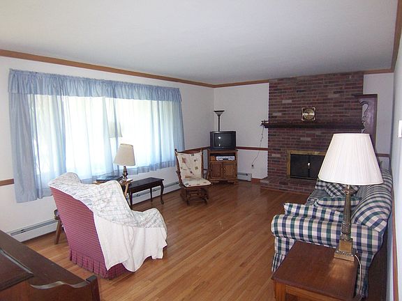 formal living room with brick fireplace