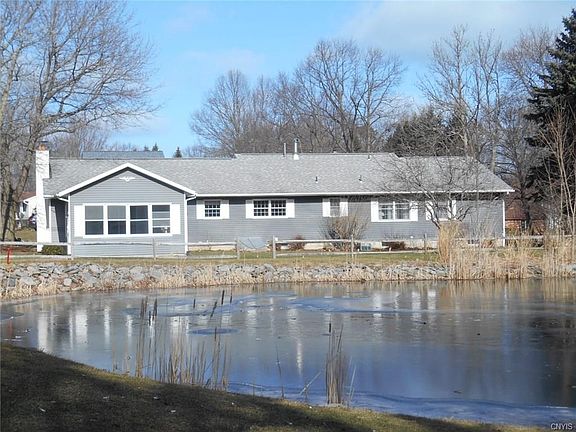 Pictured is the Rear of the Home which overlooks the Pond