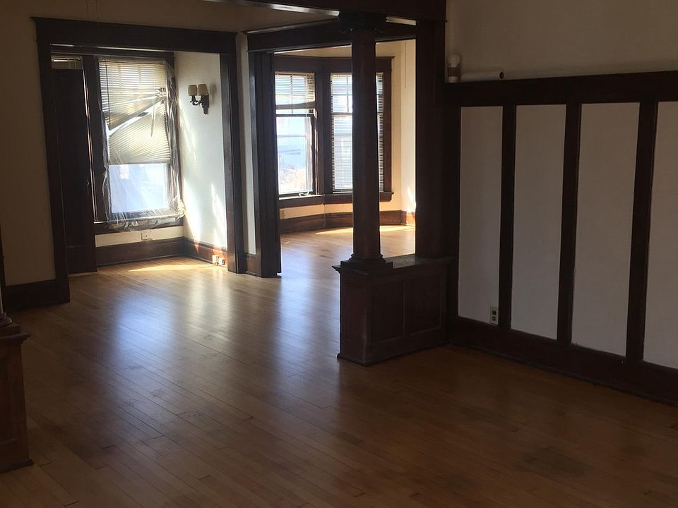 Living room.  Bedroom behind french doors. Refinshed floors.