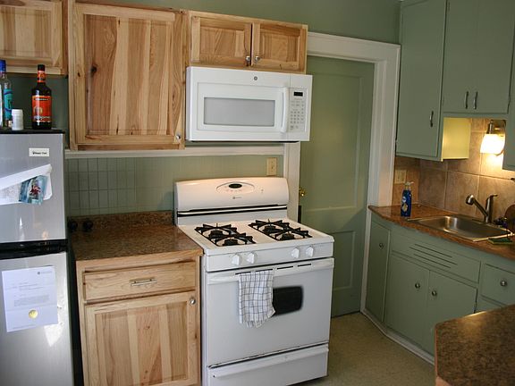 Updated kitchen with hickory cabinets. Stove, fridge, micro