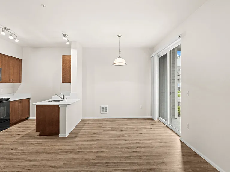 Spacious open-concept living and dining area with modern finishes and easy access to your private patio. Spacious open-concept living and dining area with modern finishes and easy access to your private patio.