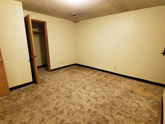 Larger of the two bedrooms looking toward closet