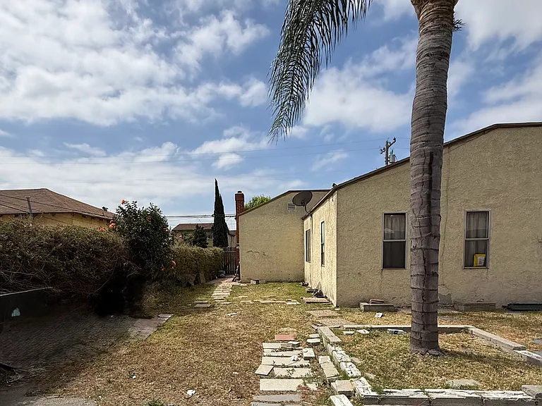 Additional yard space wraps around side of house from the rear.