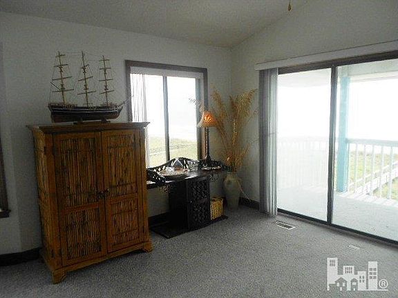 Combination living room dining room has windows all around.  You can see the ocean from every window.