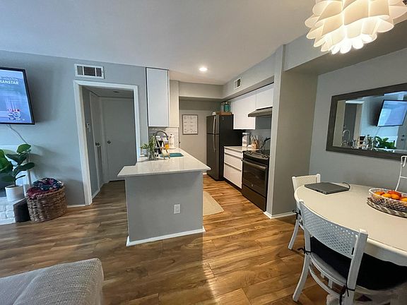 Dining space next to kitchen, with cool light fixture
