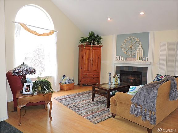 Living room with wood burning fireplace.
