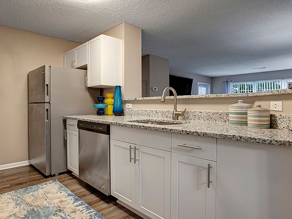 Reimagined kitchen with granite countertops and stainless steel appliances