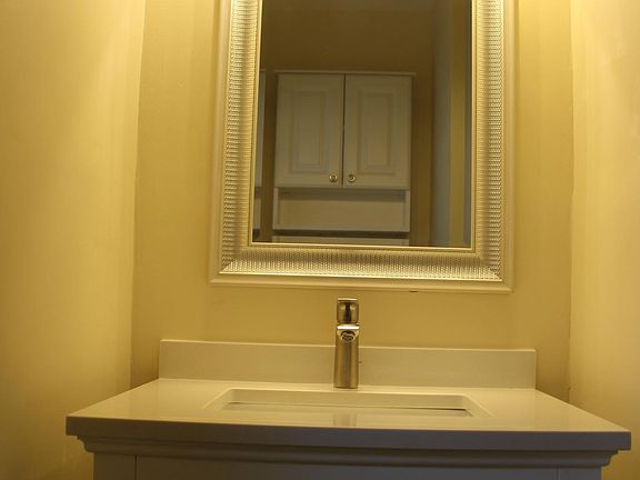Vanity & faucet w/ mirror. Medicine cabinet visible in mirro
