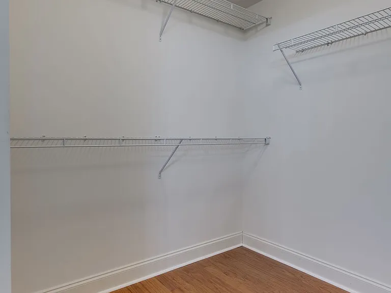 The walk-in closet is quite spacious & serves the primary bedroom.