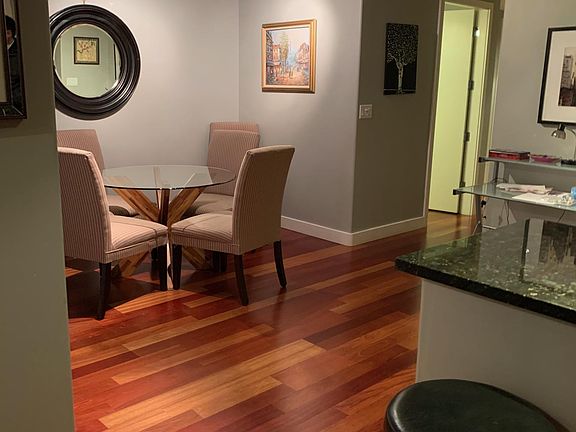 Dining room with views of the patio just outside. Table, chairs, and stools available for purchase,