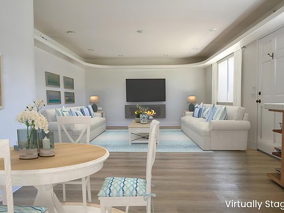 Staged photo of family room to demonstrate furniture, tv and portable electric fireplace placement ideas.