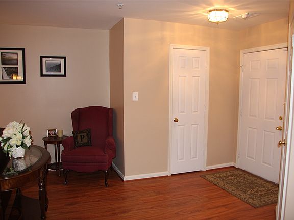 Entry way, powder room through door and hall closet on oppos