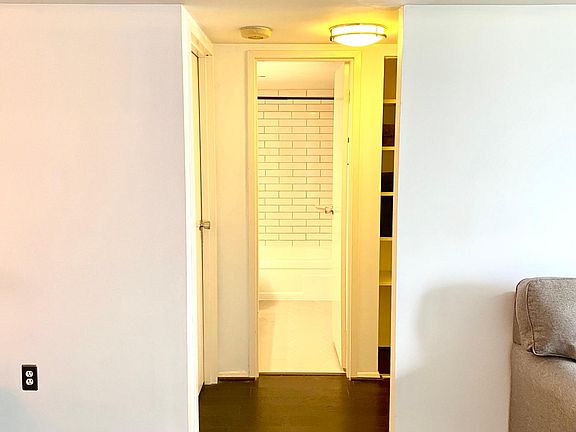standing in living room facing bathroom