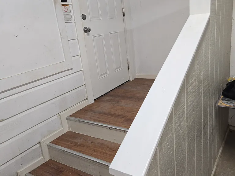 Stairs and Landing leading into Living Room from Laundry Room