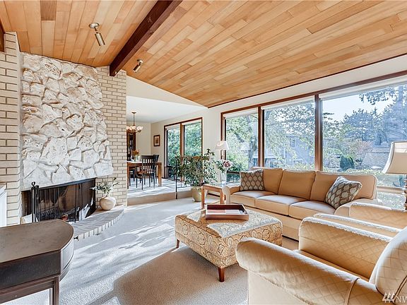 Formal living room with vaulted ceilings and stone fireplace.  