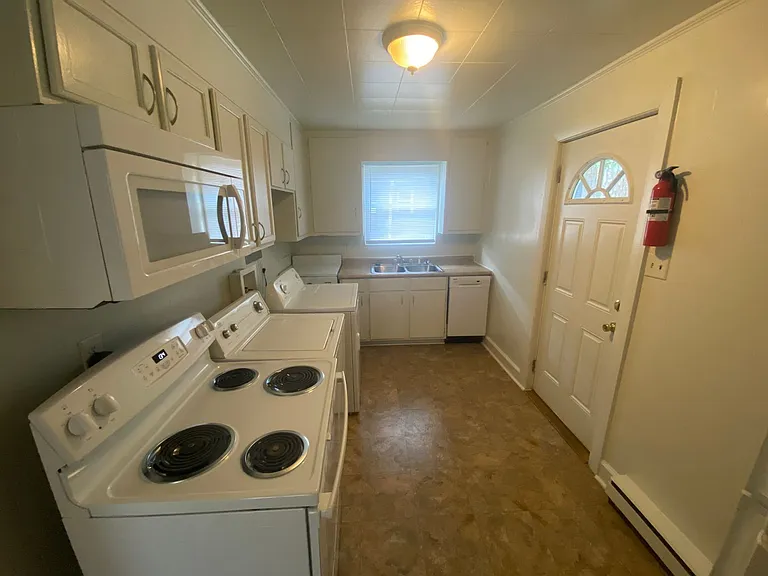 Private carport, in-unit laundry, and the Lakewood strip right outside your door. — Photo 6