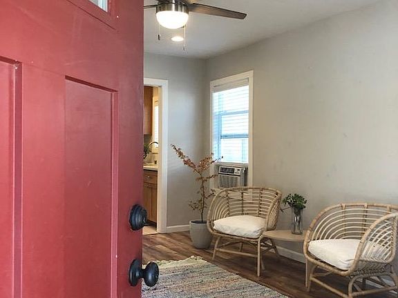 Enter into the living space with wood laminate flooring, ceiling fan, two tone paint, ample natural lighting.