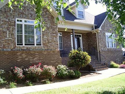 Front of House
						:
						Late June with flowers in bloom