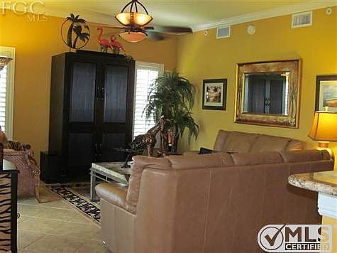 Living room with Crown molding ,Plantation shutters with Large tile flooring