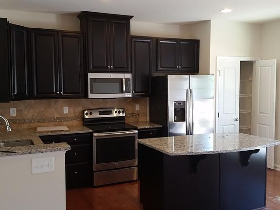 Kitchen with granite countertop, stainless appliances and ha