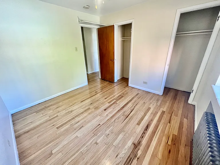 Embrace serenity in this well-lit bedroom featuring polished wood flooring. Embrace serenity in this well-lit bedroom featuring polished wood flooring.