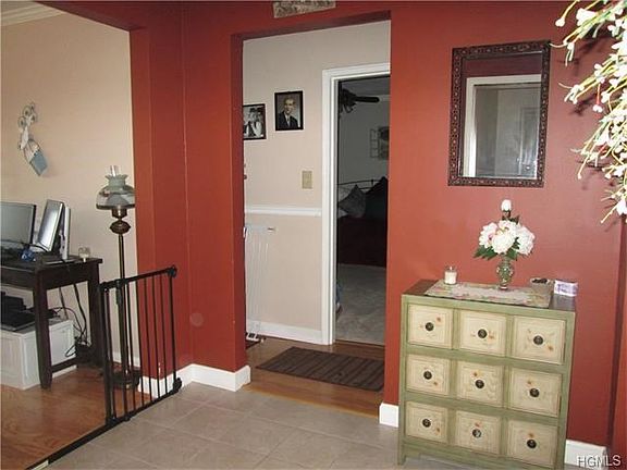 Large, tiled entry foyer with closet and walk-in pantry.