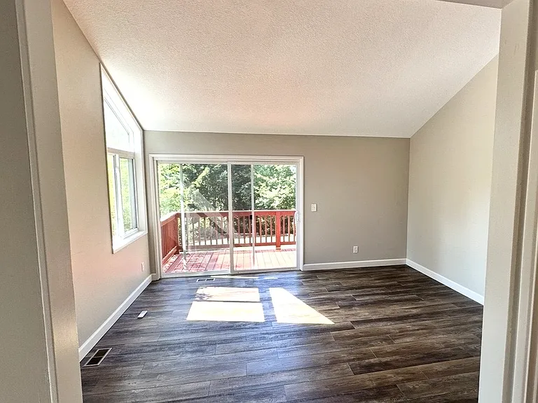 Additional living quarters with slider glass door leading to deck and overlooking backyard