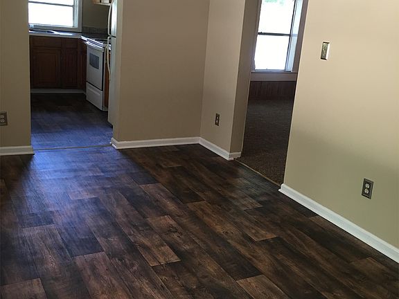 Dining room connects with kitchen, living room. View is from the laundry room