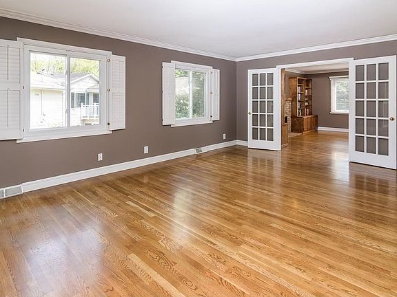 Family room is adjacent to the living room through French doors at the rear of the home.