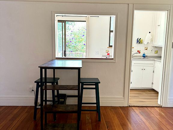 Living room looking into the kitchen and backyard
