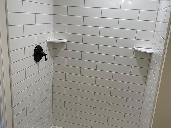 custom subway tile shower in second floor master bathroom