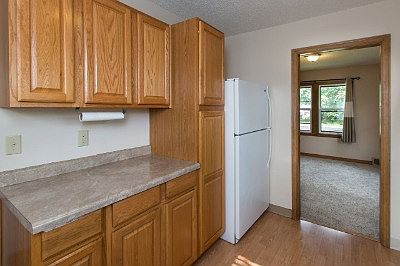 Wonderful galley style kitchen with newer cabinets and windows for natural light