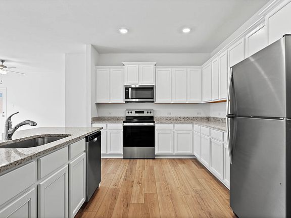 The chef ready kitchen is filled with stainless steel appliances.