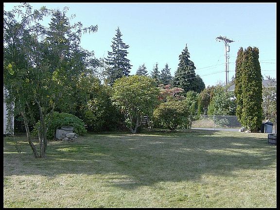 House sits on large, flat 1/2 acre corner lot