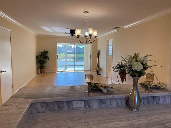 Looking from the kitchen to the dining room, living room, and lanai