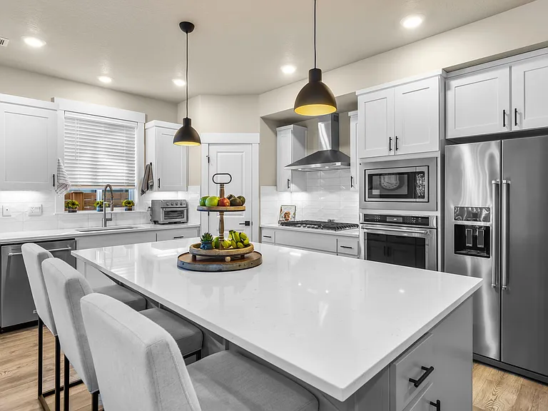 Large kitchen w/quartz countertops, island, walk-in pantry, stainless Kitchen Aid Appliances including gas cooktop, convection oven, microwave, dishwasher and refrigerator.