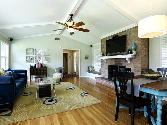 Opposite view of the sunny main living/dining area with the beautiful hardwood floors, 2 inch blinds