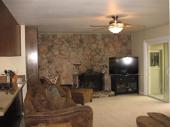 There's a dramatic fireplace wall done in attractive stone.  A sliding door offers access to the patio and backyard.