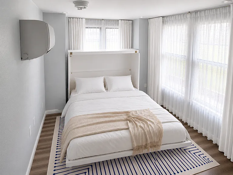 A private downstairs bedroom offers stair-free sleeping with blackout shades for uninterrupted rest.