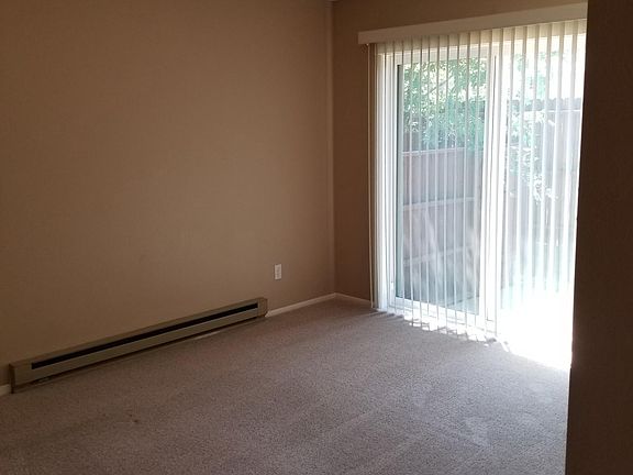 Master bedroom with sliding door to small, private patio.